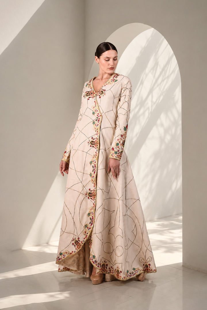 Ivory elegant overlap anarkali featuring flattering V-neckline with full sleeves, and adorned with delicate geometric linework &amp; multicolor floral embroidery.