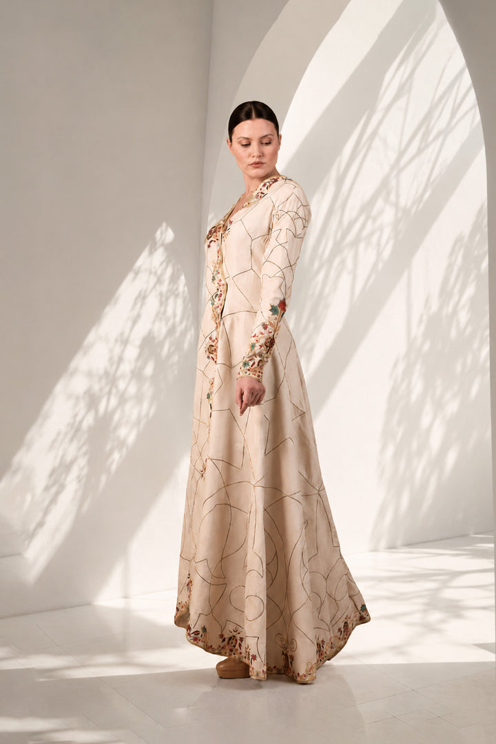 Ivory elegant overlap anarkali featuring flattering V-neckline with full sleeves, and adorned with delicate geometric linework &amp; multicolor floral embroidery.