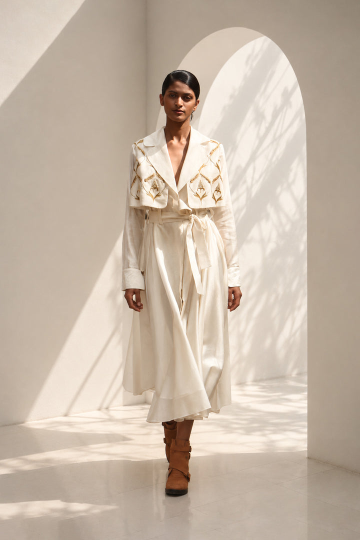 Ivory wrap dress featuring delicate embroidery, sheer sleeves and fluid drape.