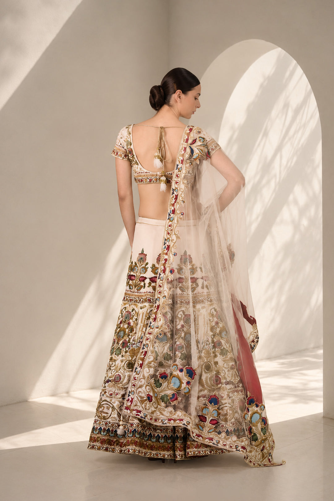 Ivory embroidered lehenga set featuring intricately embroidered blouse with scoop neckline and short sleeves, full flared lehenga paired with sheer dupatta.
