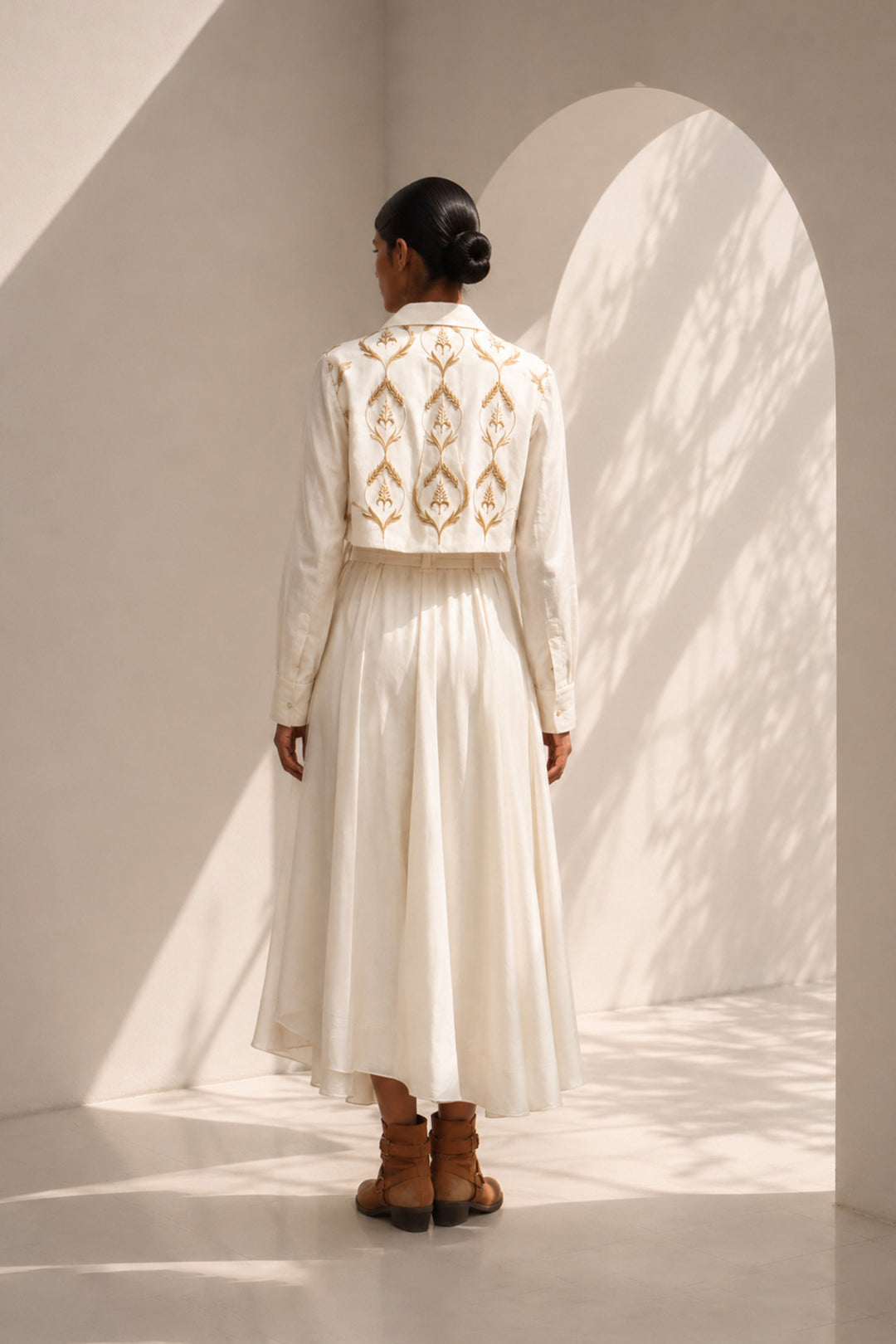 Ivory wrap dress featuring delicate embroidery, sheer sleeves and fluid drape.