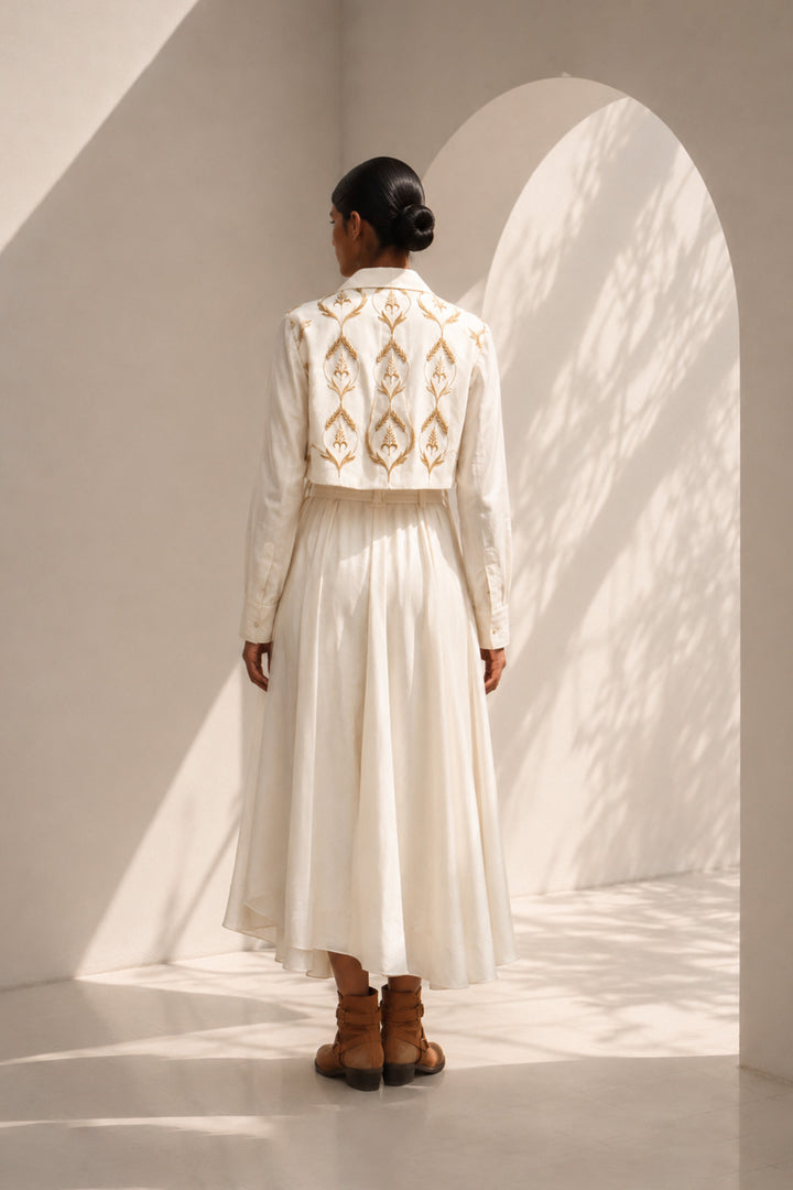 Ivory wrap dress featuring delicate embroidery, sheer sleeves and fluid drape.