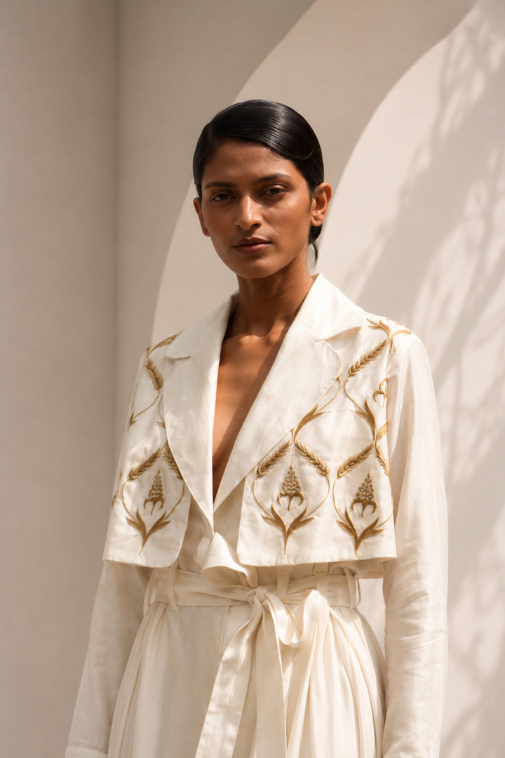 Ivory wrap dress featuring delicate embroidery, sheer sleeves and fluid drape.