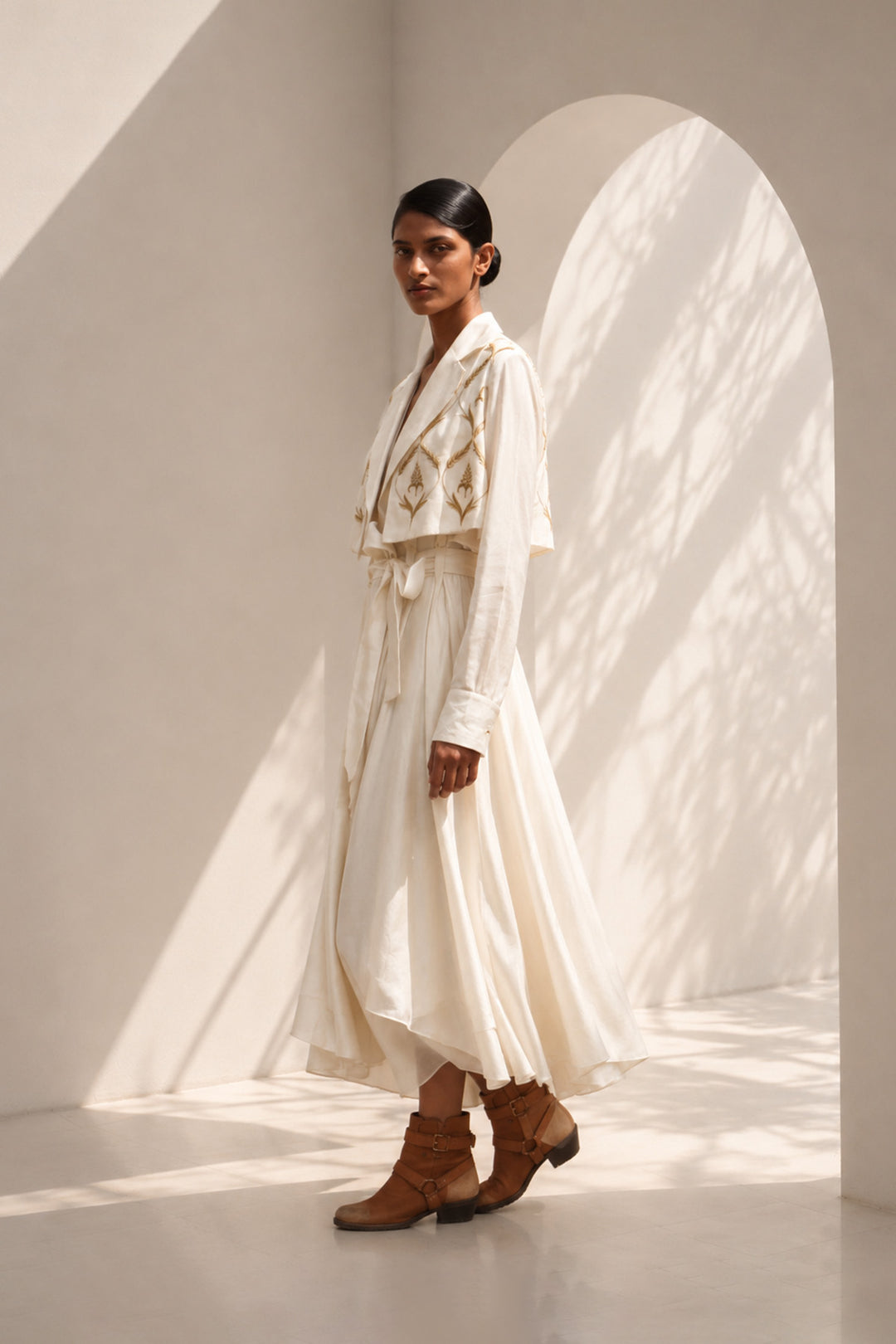 Ivory wrap dress featuring delicate embroidery, sheer sleeves and fluid drape.