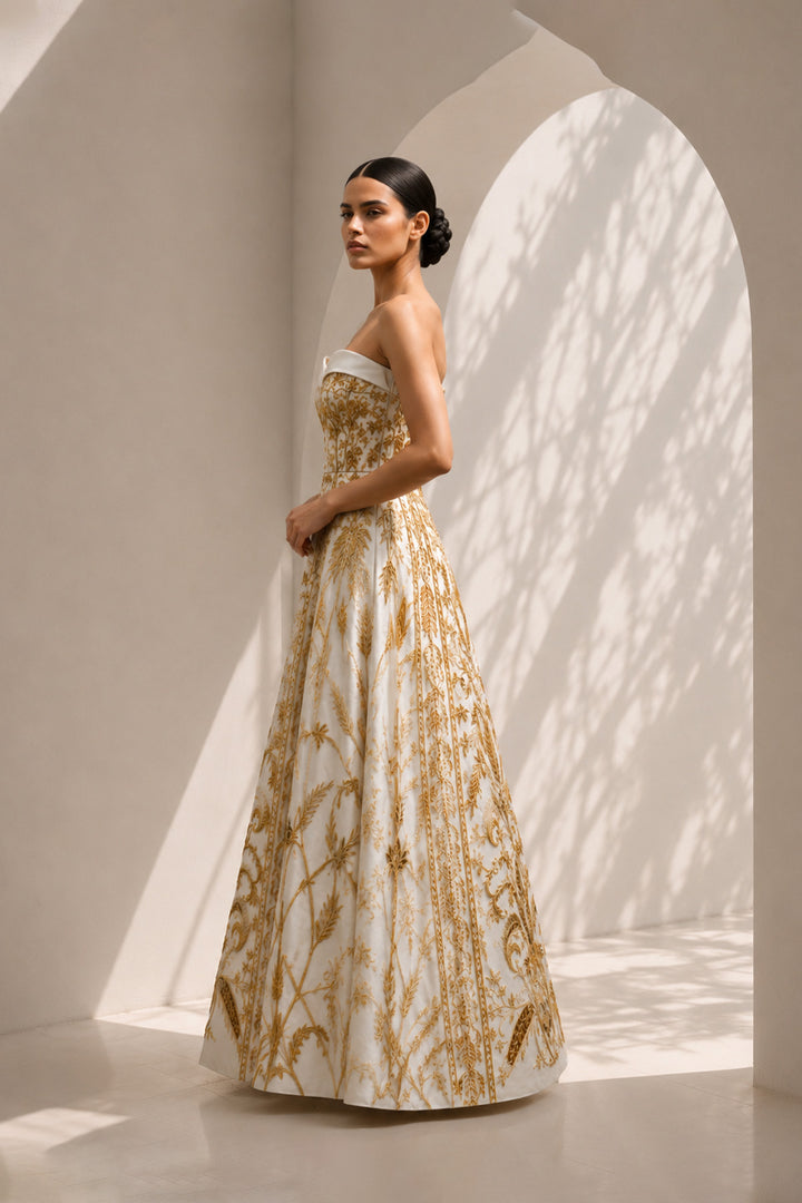 Ivory strapless sweetheart neckline statement gown enriched with gold embroidery.