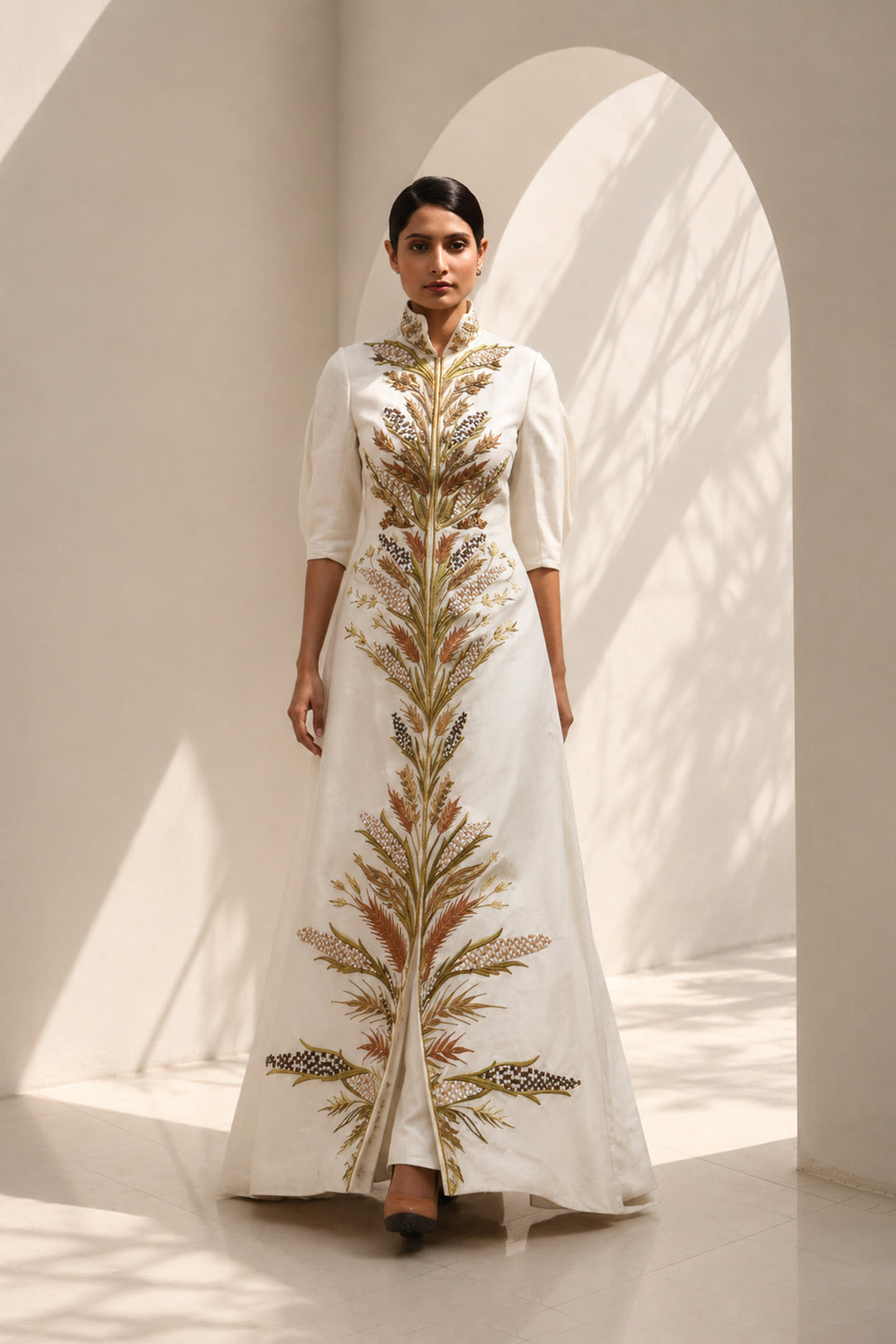 Ivory embroidered jacket gown featuring a regal high collar , and a graceful floor-length silhouette.
