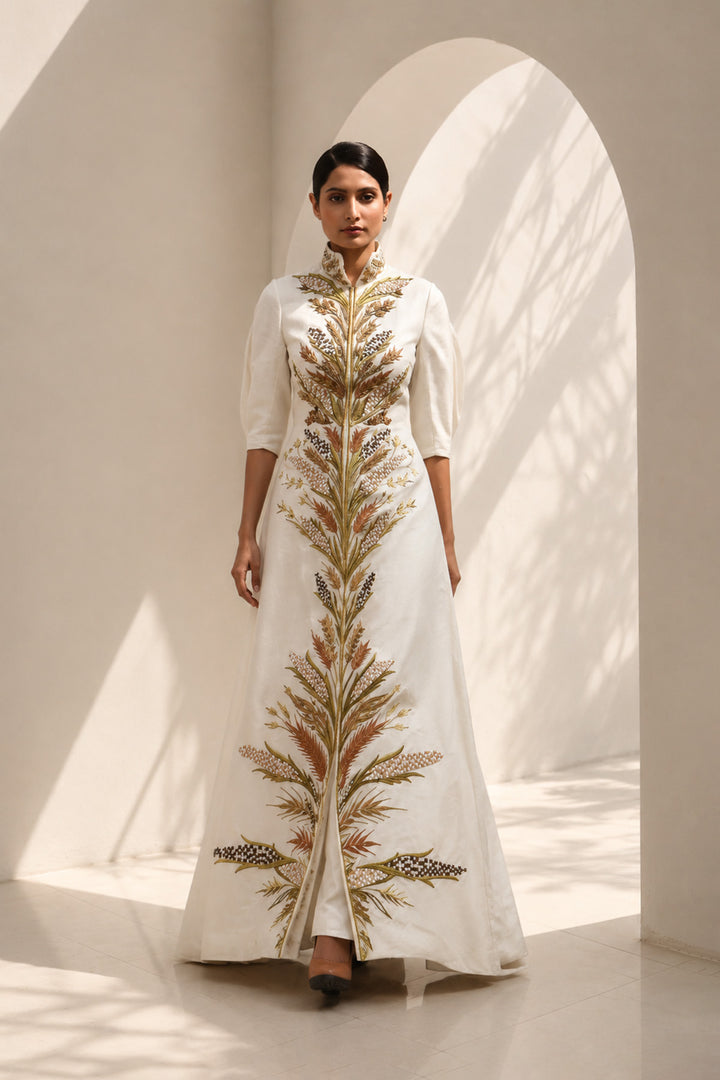 Ivory embroidered jacket gown featuring a regal high collar , and a graceful floor-length silhouette.