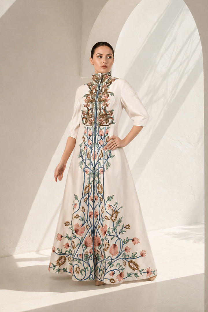 Ivory statement jacket gown adorned with vibrant floral embroidery, elegant high-neck collar detailing and tailored bodice with flatering fit.