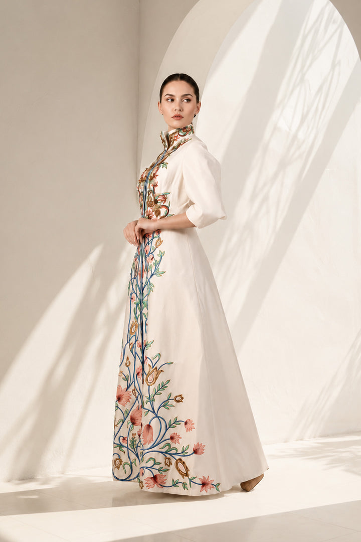 Ivory statement jacket gown adorned with vibrant floral embroidery, elegant high-neck collar detailing and tailored bodice with flatering fit.
