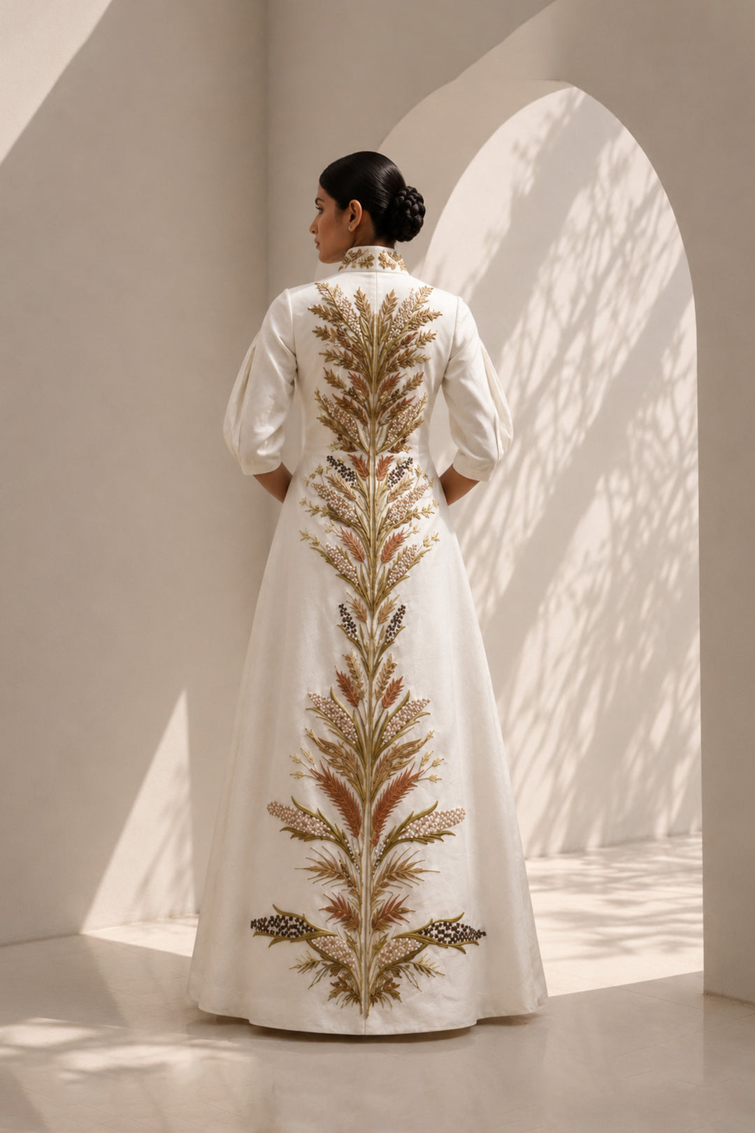 Ivory embroidered jacket gown featuring a regal high collar , and a graceful floor-length silhouette.