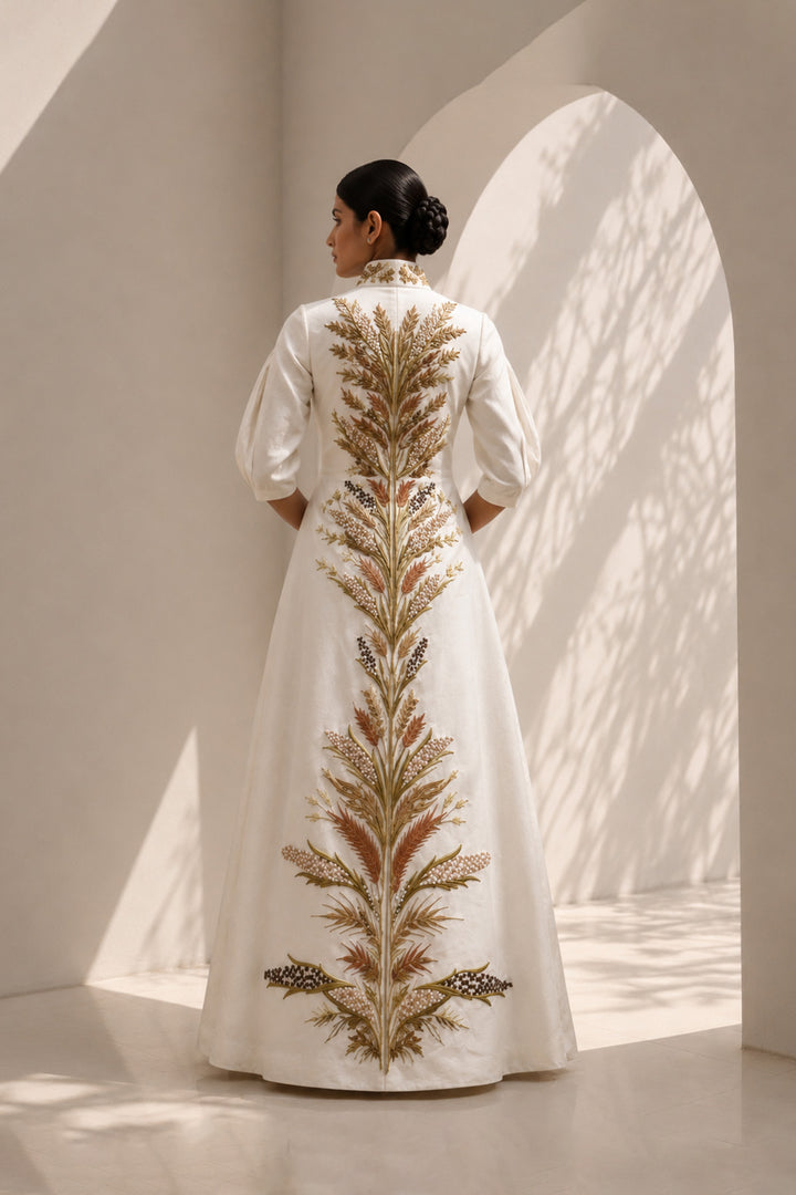 Ivory embroidered jacket gown featuring a regal high collar , and a graceful floor-length silhouette.