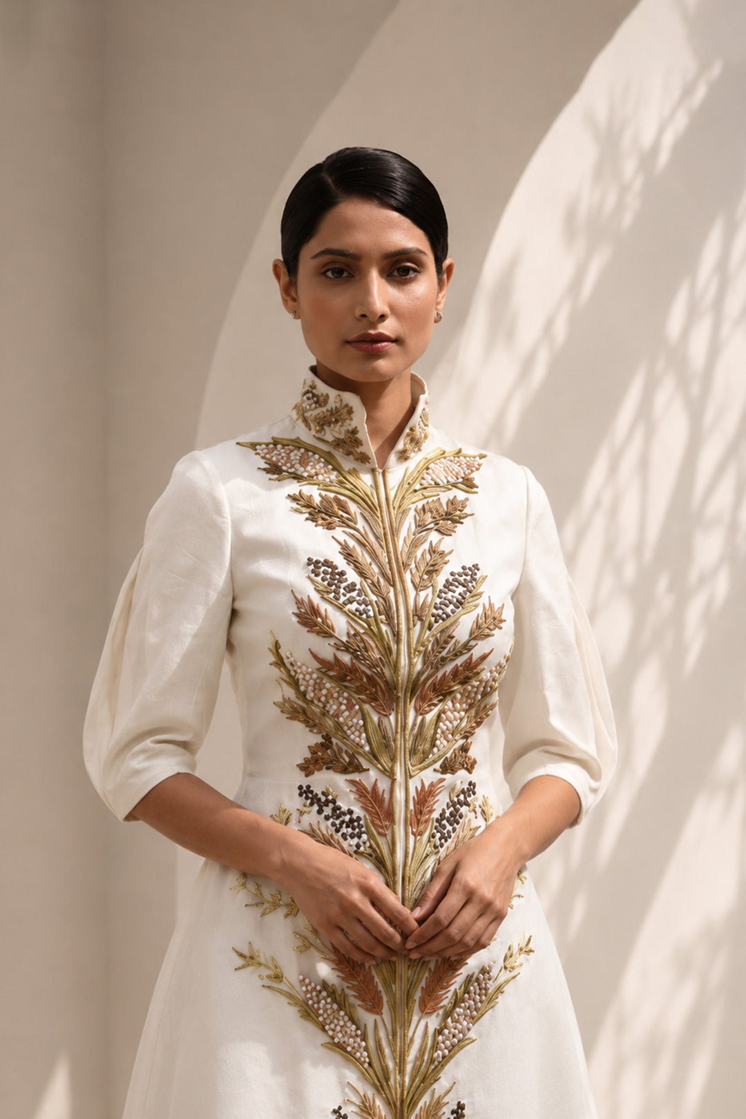 Ivory embroidered jacket gown featuring a regal high collar , and a graceful floor-length silhouette.