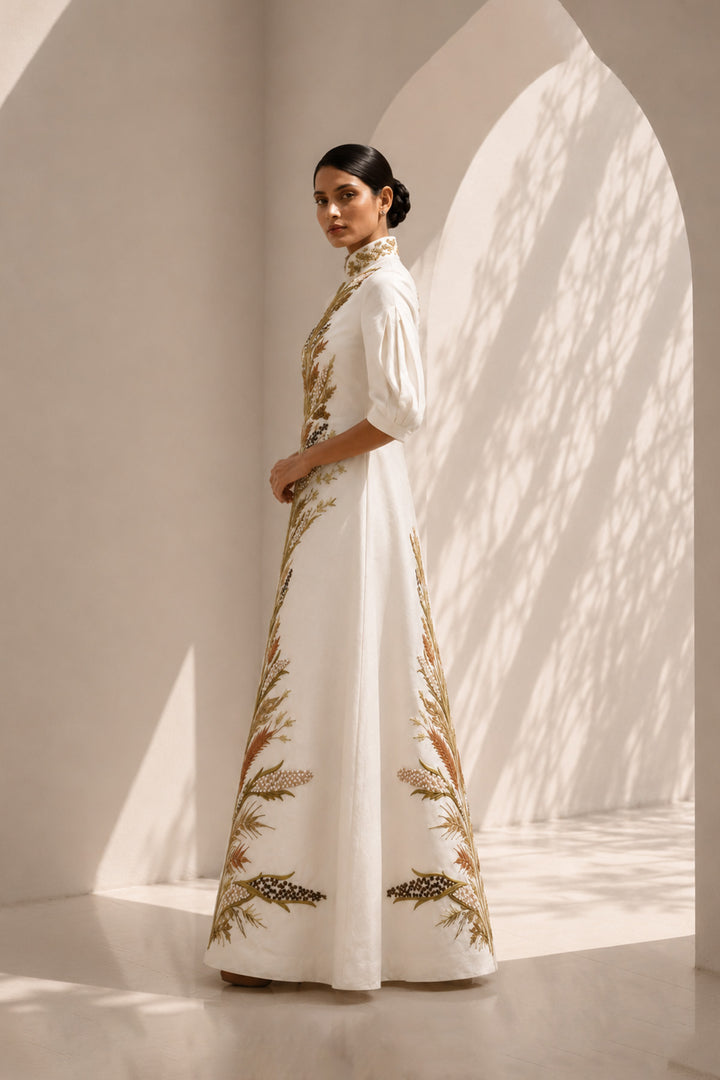Ivory embroidered jacket gown featuring a regal high collar , and a graceful floor-length silhouette.