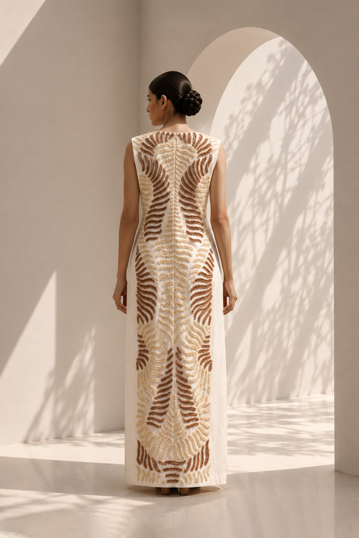 Ivory column dress elevated with intricate nature-inspired embroidery, creating a striking balance of minimalism and artisanal detail.