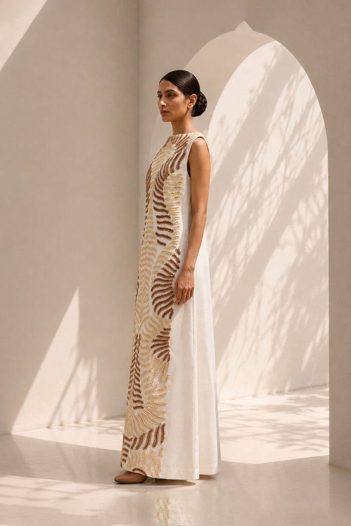 Ivory column dress elevated with intricate nature-inspired embroidery, creating a striking balance of minimalism and artisanal detail.