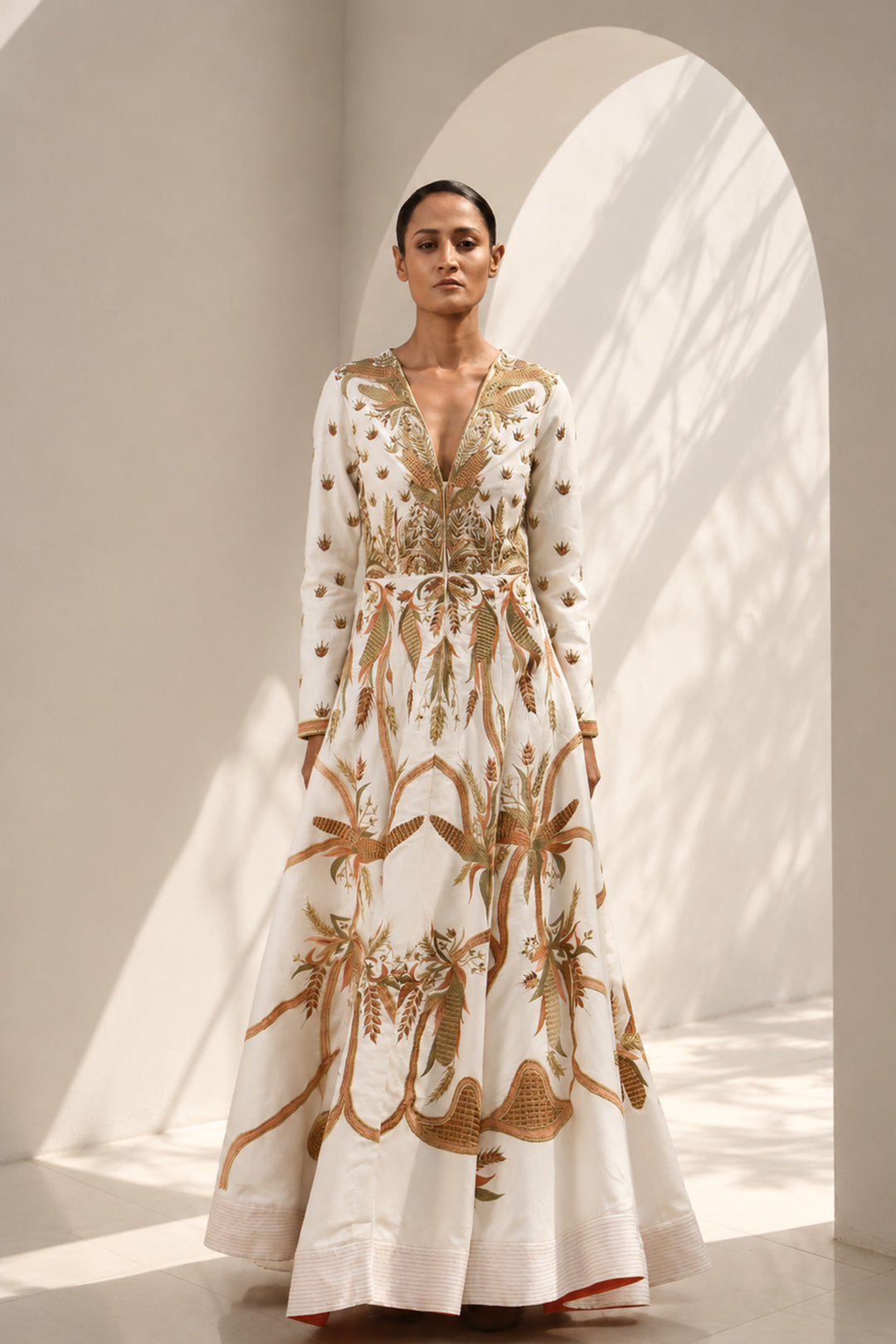 Ivory deep V-neckline embroidered gown with structured bodice, featuring flared silhouettewith graceful volume.