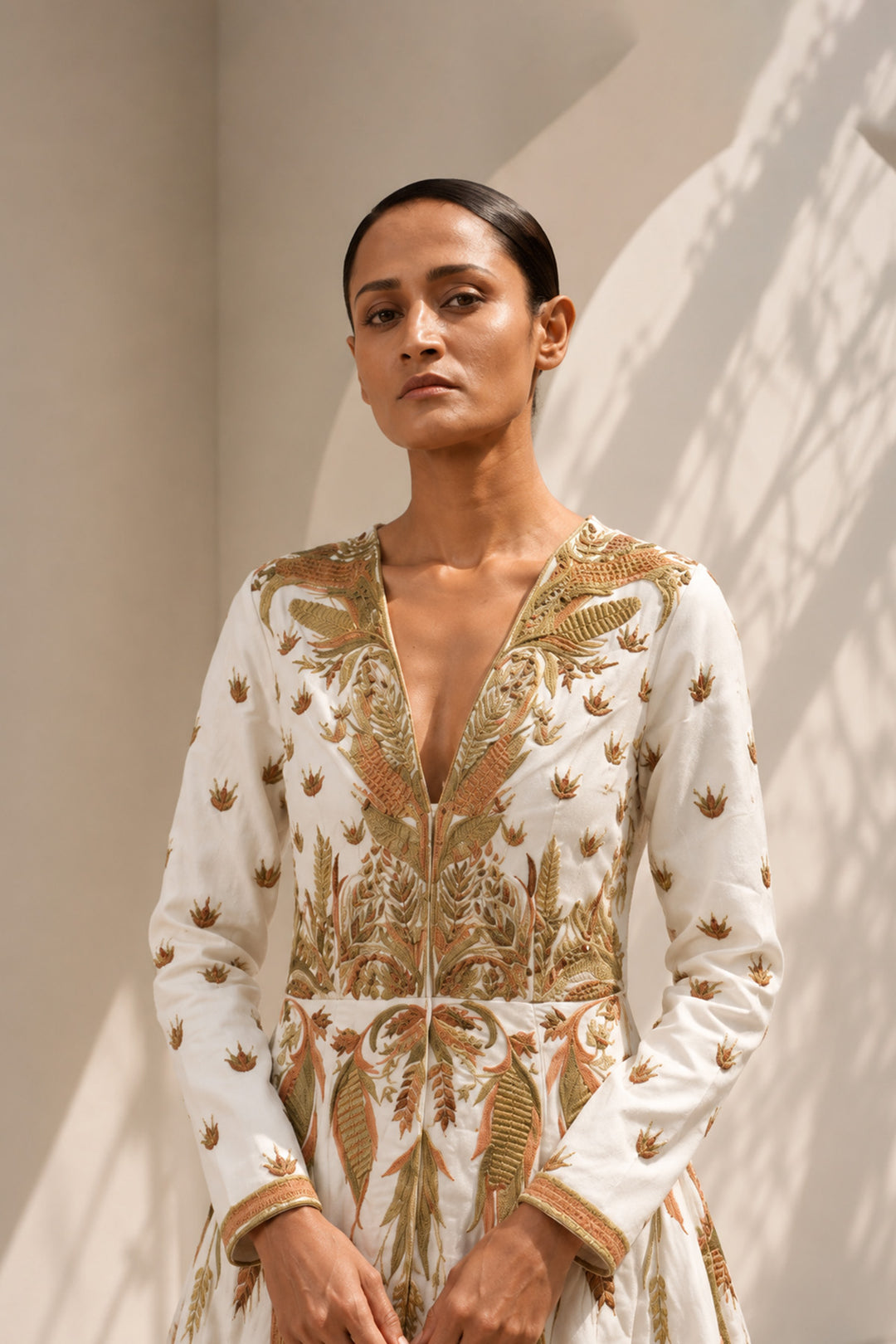 Ivory deep V-neckline embroidered gown with structured bodice, featuring flared silhouettewith graceful volume.