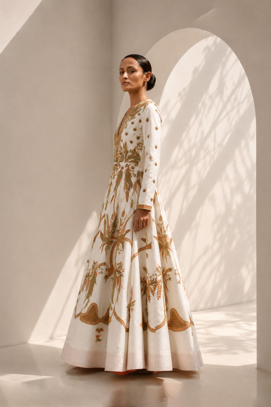 Ivory deep V-neckline embroidered gown with structured bodice, featuring flared silhouettewith graceful volume.