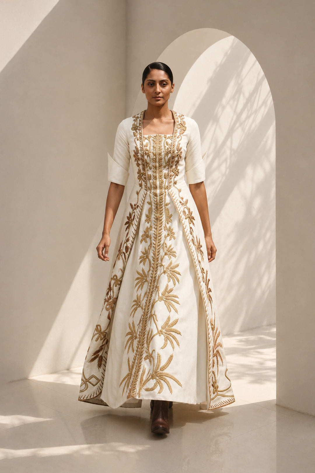 Ivory embroidered panel gown featuring elegant square neckline, structured bodice &amp; antique gold handcrafted threadwork.