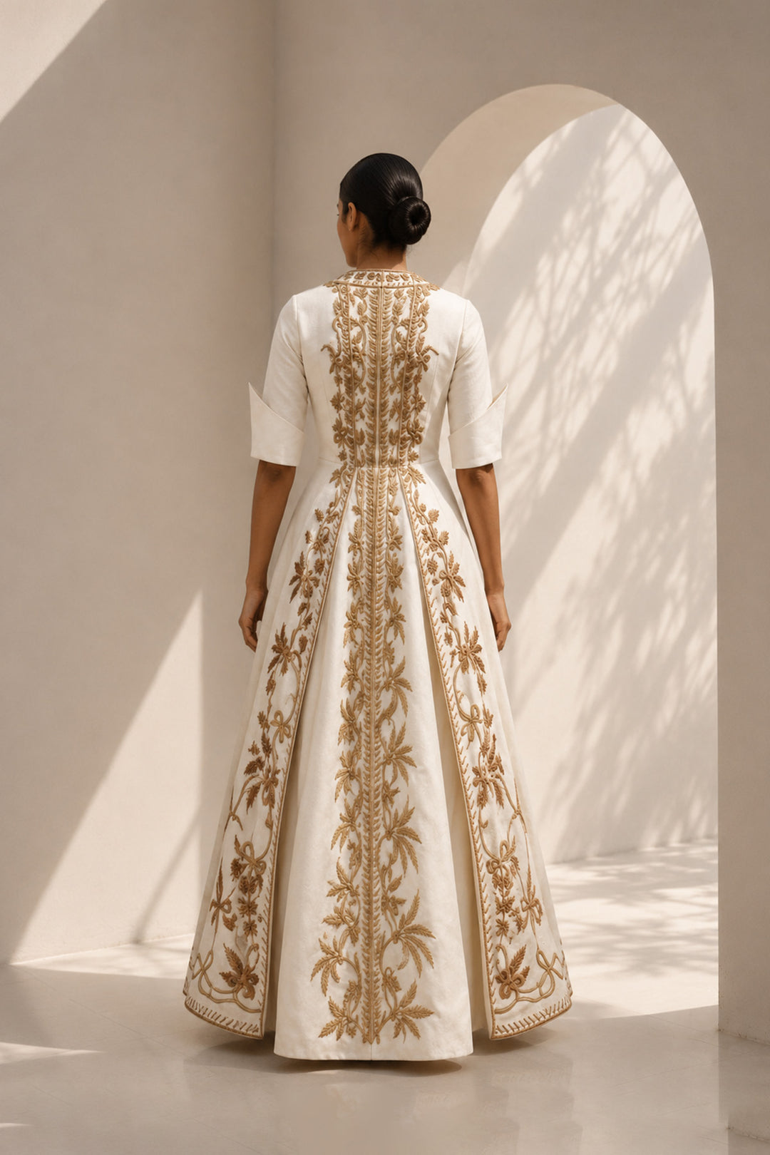 Ivory embroidered panel gown featuring elegant square neckline, structured bodice &amp; antique gold handcrafted threadwork.