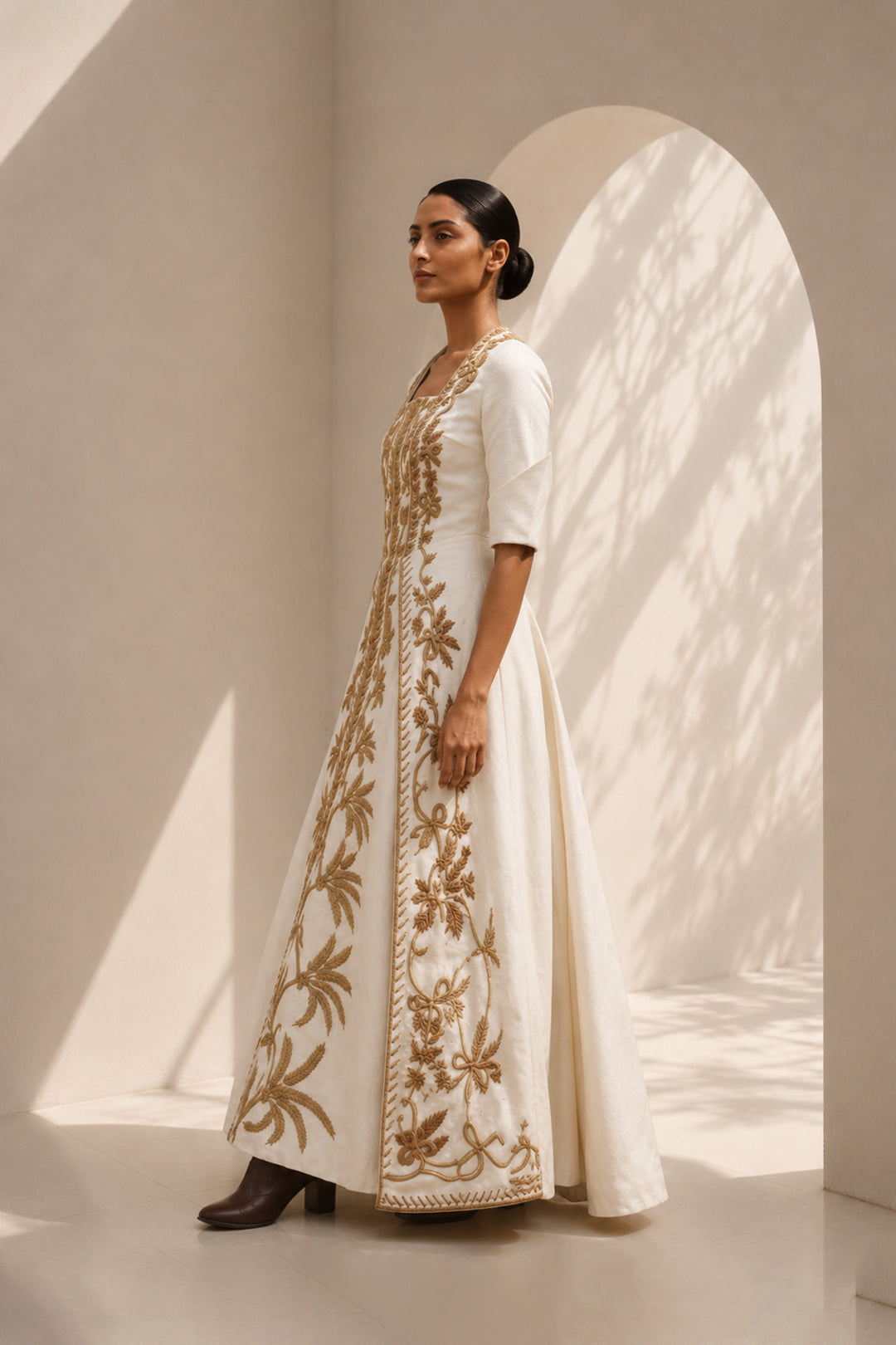 Ivory embroidered panel gown featuring elegant square neckline, structured bodice &amp; antique gold handcrafted threadwork.