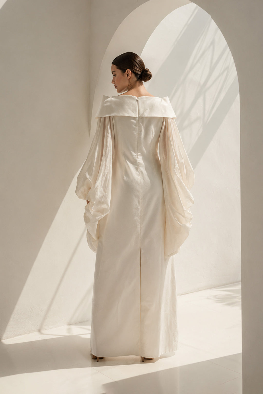 Ivory gown featuring a richly embroidered floral bodice, dramatic sheer organza sleeves, and a graceful off-shoulder neckline.
