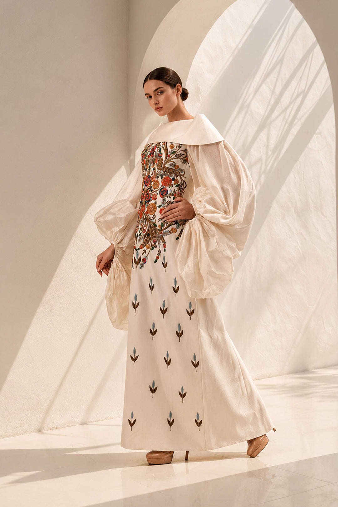 Ivory gown featuring a richly embroidered floral bodice, dramatic sheer organza sleeves, and a graceful off-shoulder neckline.