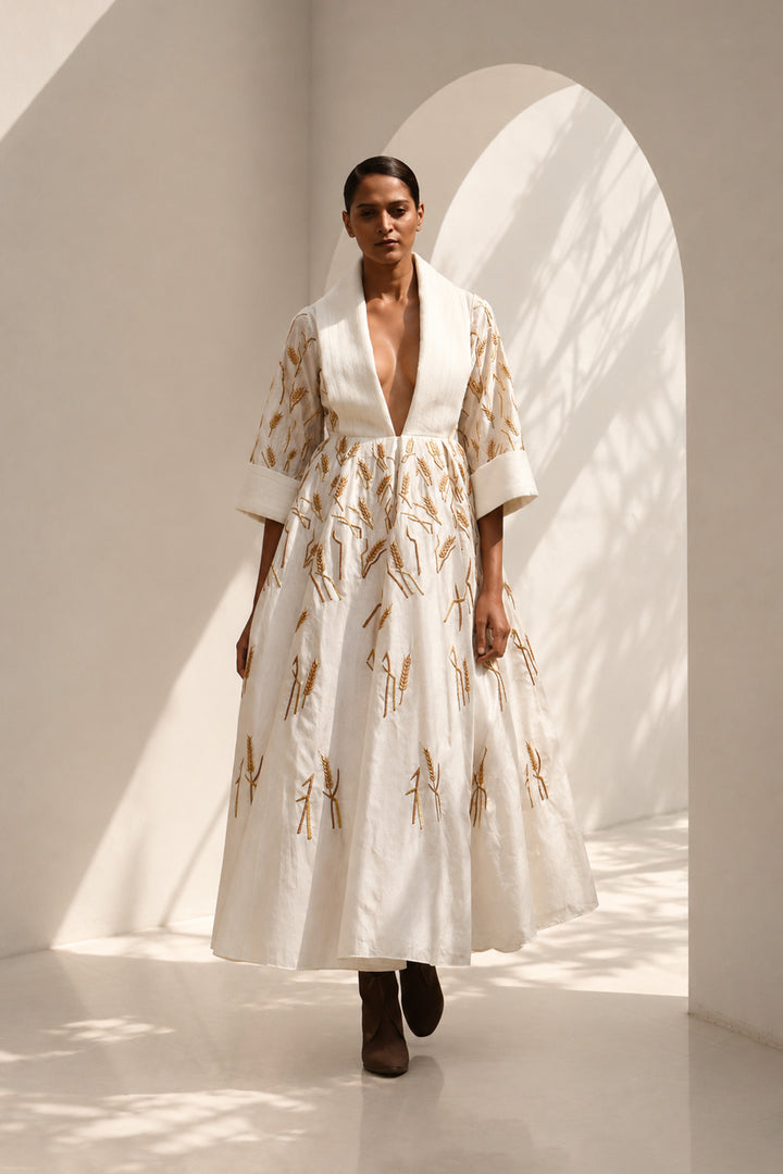 Ivory embroidered midi gown featuring a dramatic shawl collar, deep V-neckline, relaxed elbow-length sleeves &amp; voluminous flare.