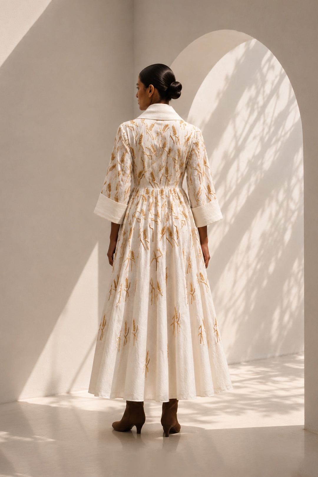 Ivory embroidered midi gown featuring a dramatic shawl collar, deep V-neckline, relaxed elbow-length sleeves &amp; voluminous flare.