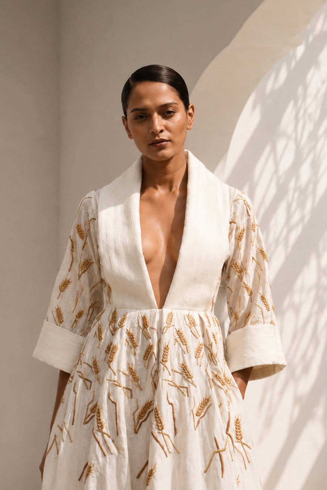 Ivory embroidered midi gown featuring a dramatic shawl collar, deep V-neckline, relaxed elbow-length sleeves &amp; voluminous flare.