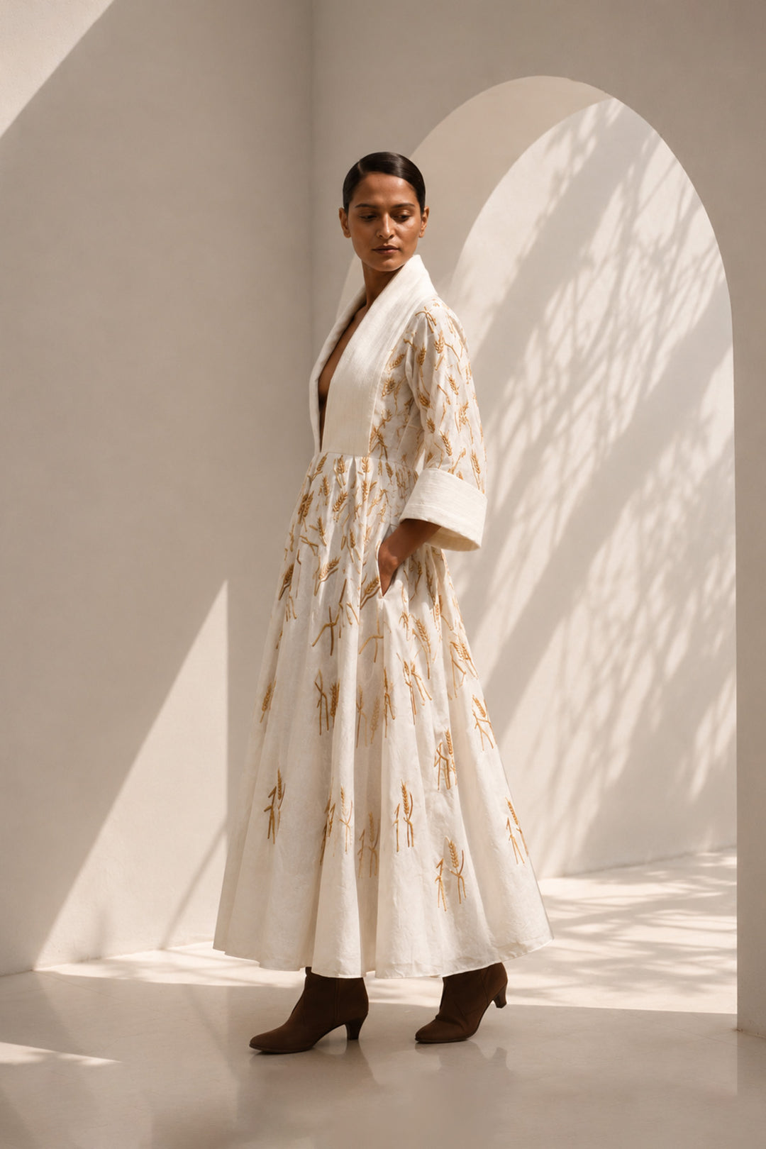 Ivory embroidered midi gown featuring a dramatic shawl collar, deep V-neckline, relaxed elbow-length sleeves &amp; voluminous flare.