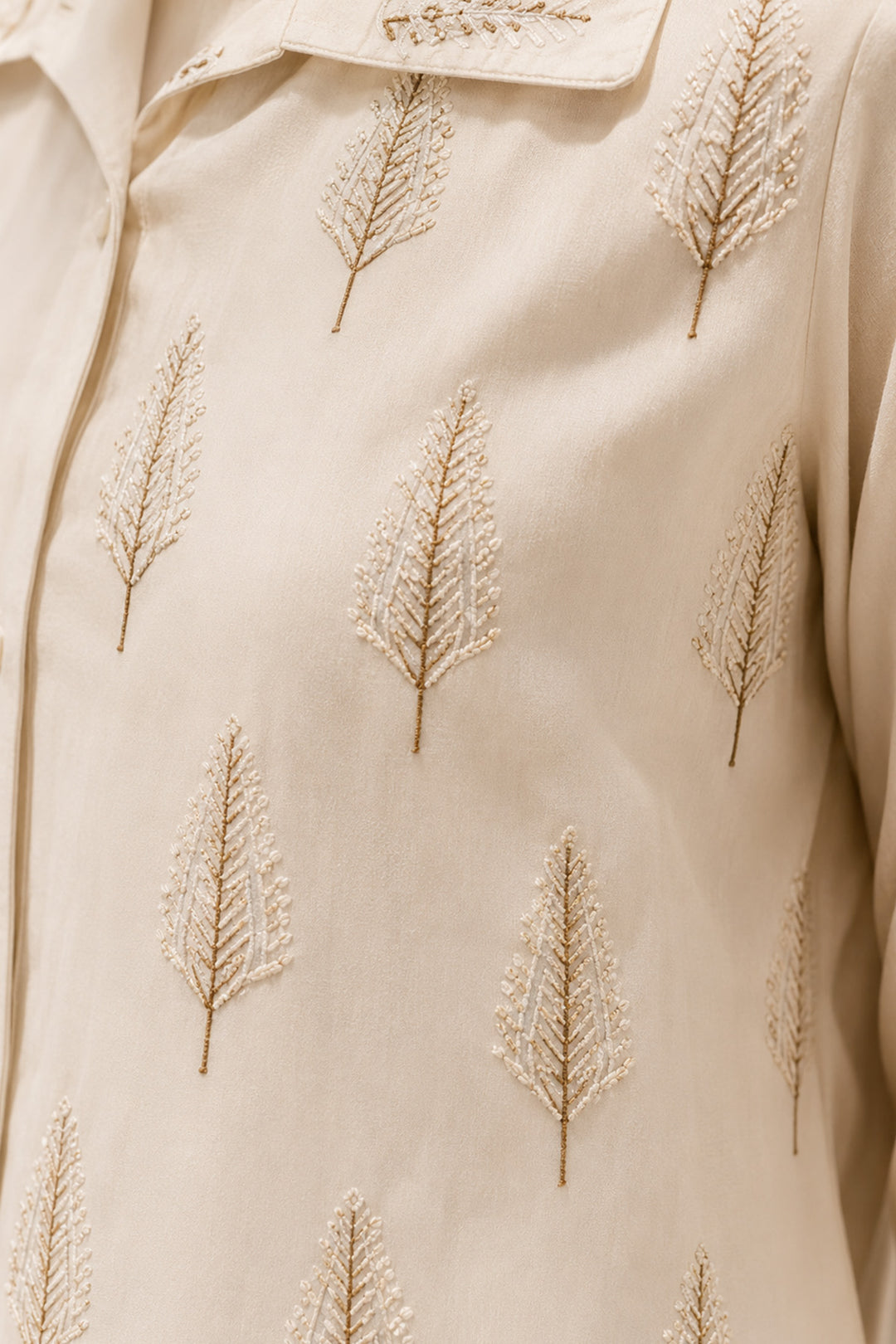 Ivory layered ensemble featuring a delicately printed overlay and flowing drape.
