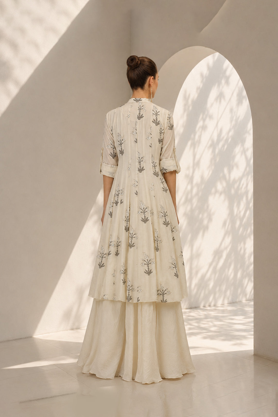 Ivory layered ensemble adorned with printed kurta paired with flared skirt.