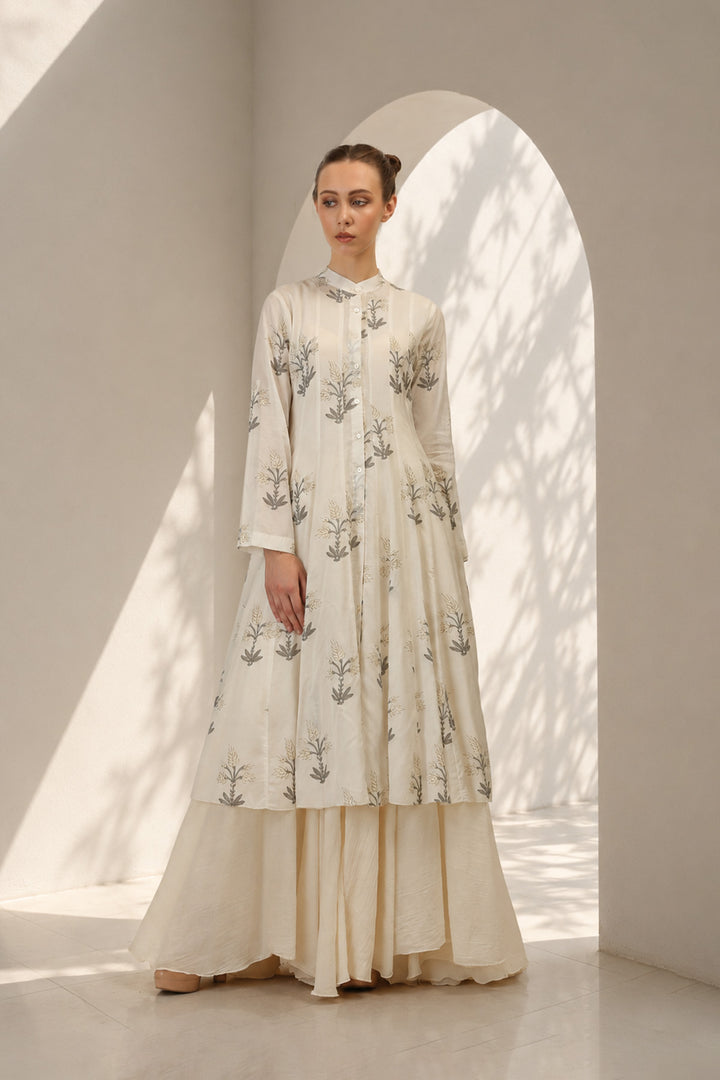 Ivory layered ensemble adorned with printed kurta paired with flared skirt.