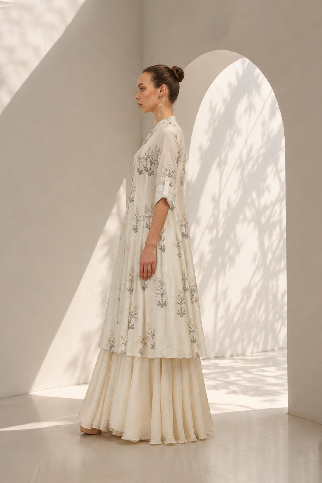 Ivory layered ensemble adorned with printed kurta paired with flared skirt.
