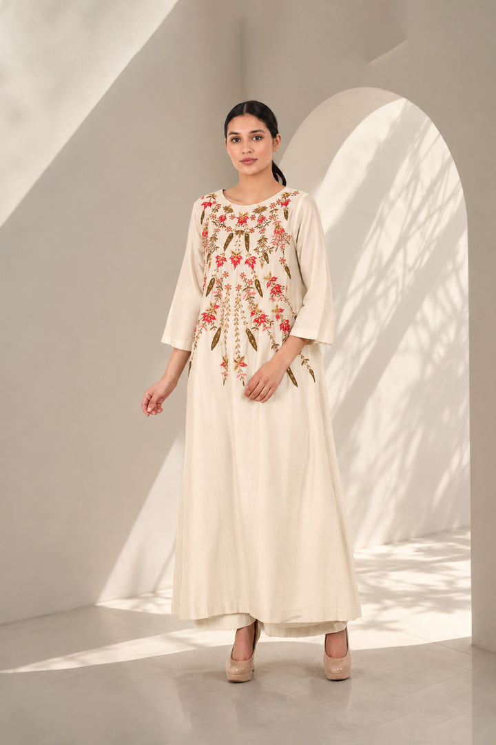 Ivory A-line dress featuring classic round neckline &amp; adorned with intricate floral embroidery.