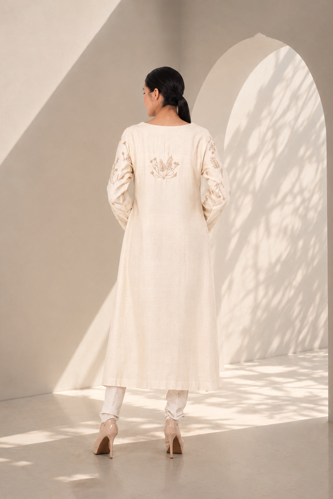Ivory kurta set featuring delicate botanical prints, designed with a graceful straight silhouette, classic round neckline, full-length sleeves.