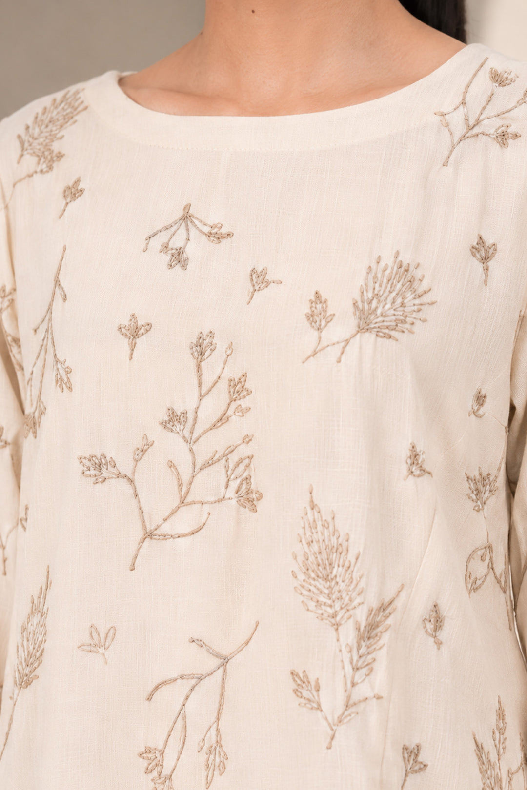 Ivory kurta set featuring delicate botanical prints, designed with a graceful straight silhouette, classic round neckline, full-length sleeves.