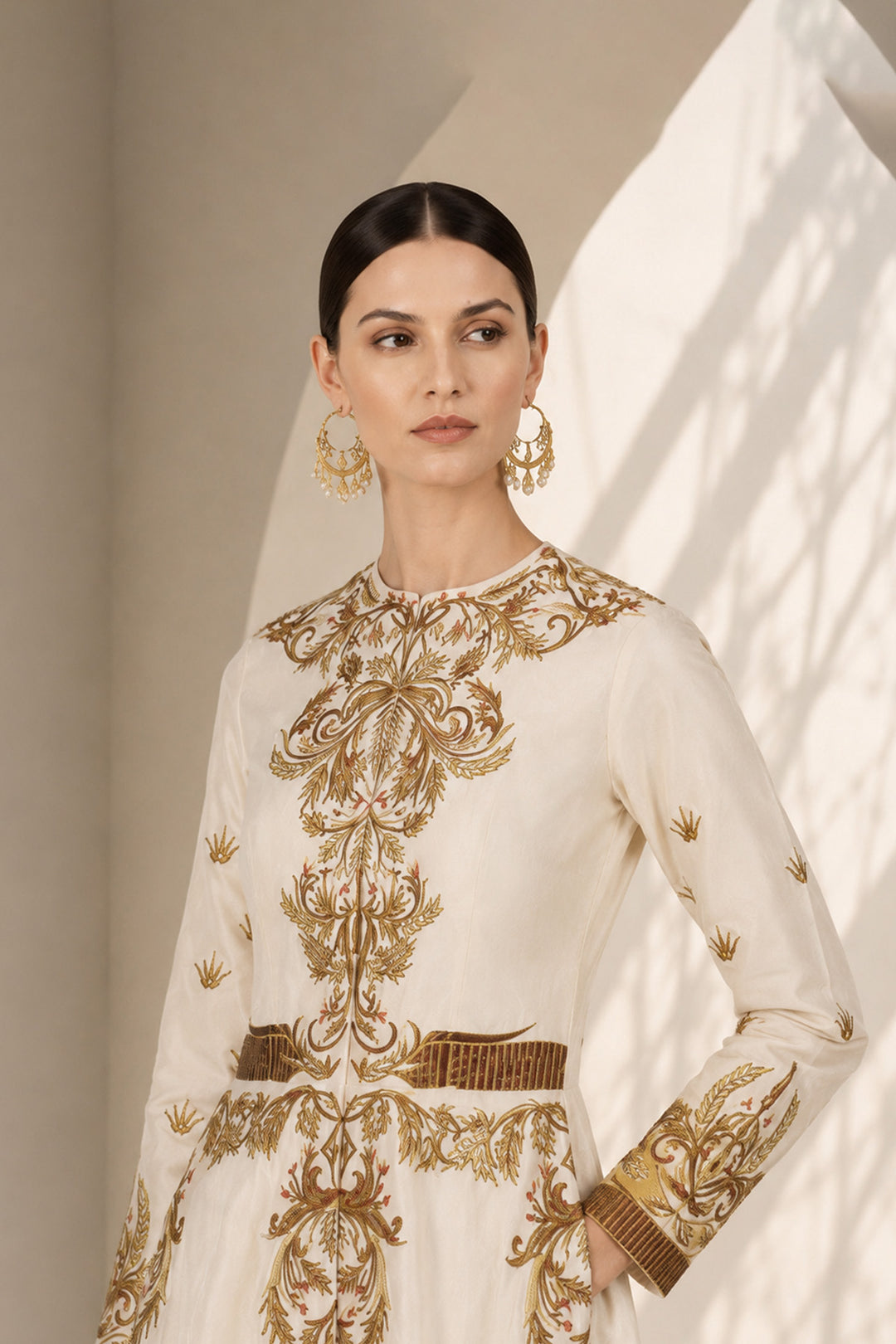 Ivory embroidered gown featuring regal placement embroidery, structured bodice and graceful flared silhouette.