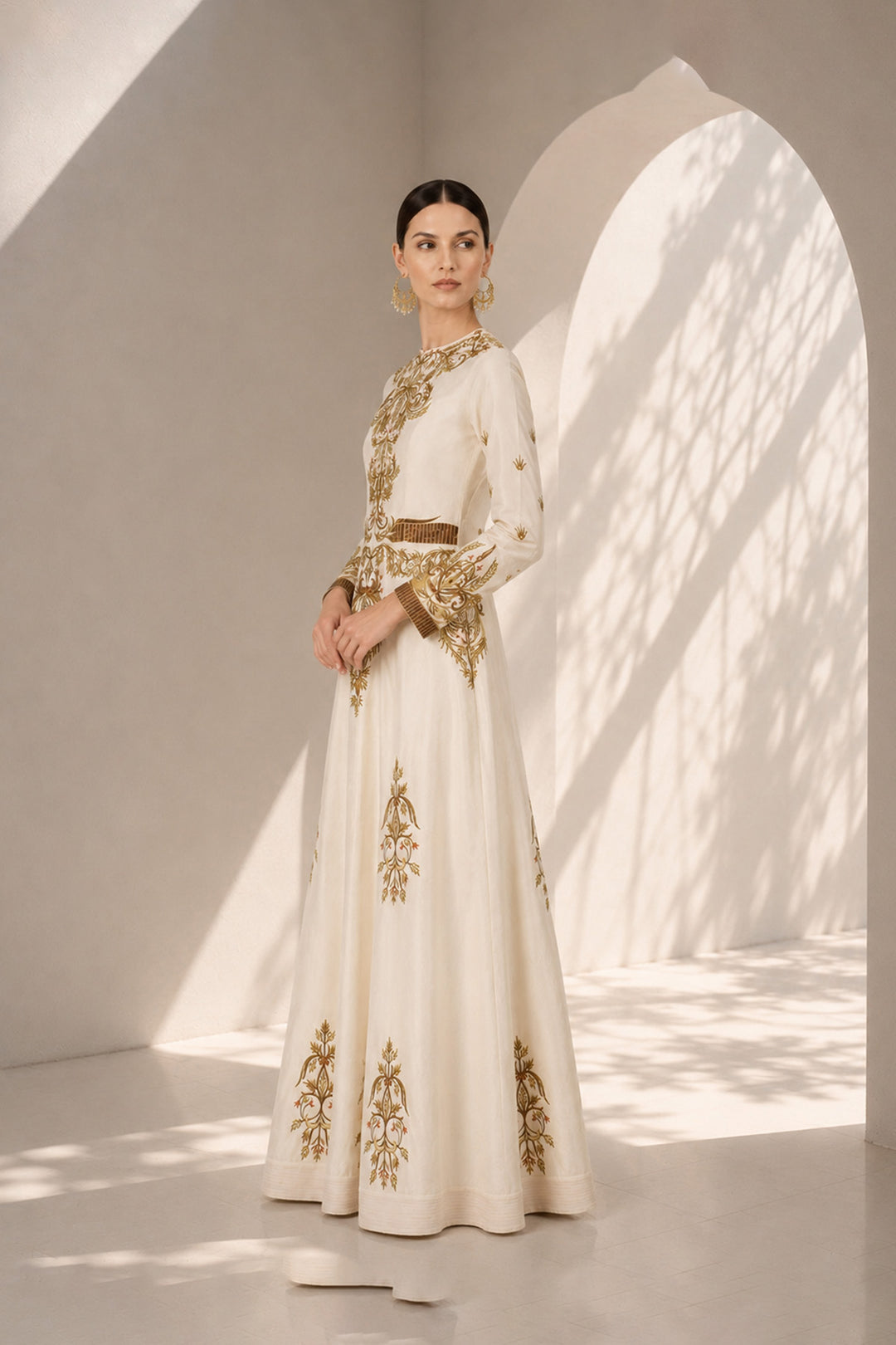 Ivory embroidered gown featuring regal placement embroidery, structured bodice and graceful flared silhouette.