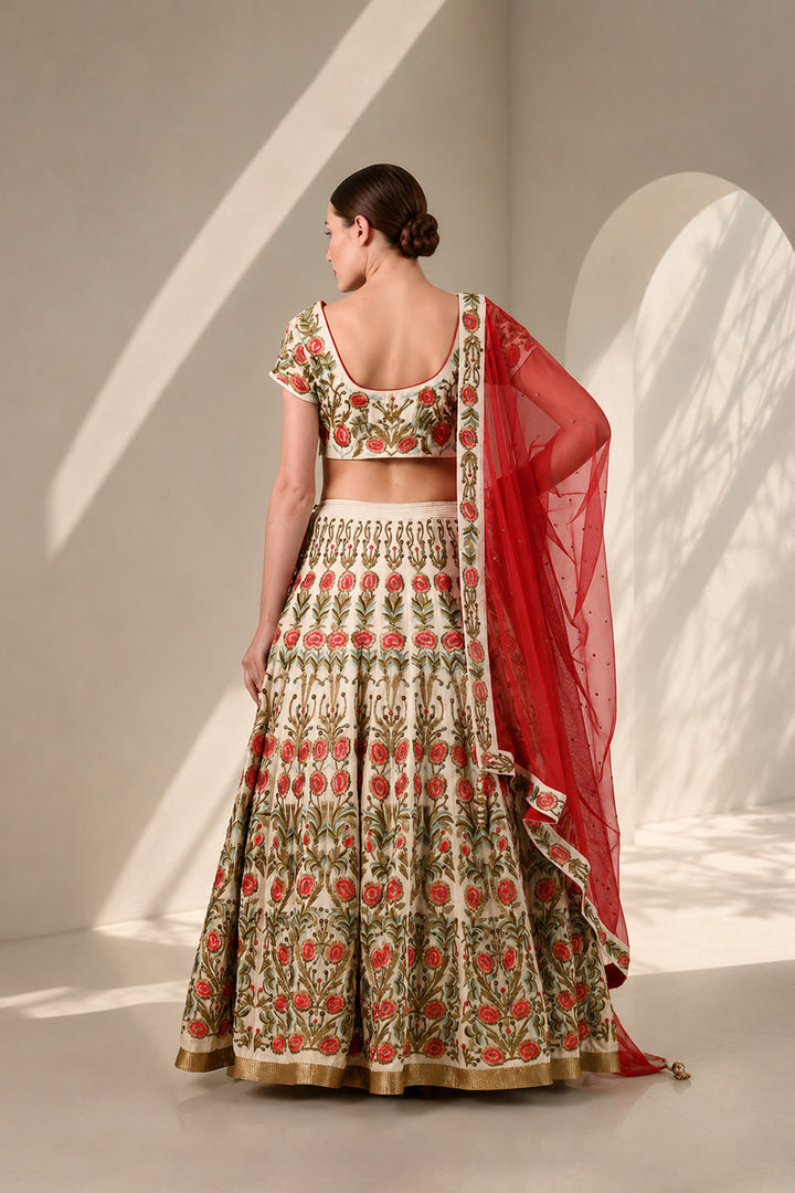 Ivory lehenga set featuring handcrafted floral embroidery on blouse &amp; skirt, a statement flared skirt and vibrant sheer dupatta.