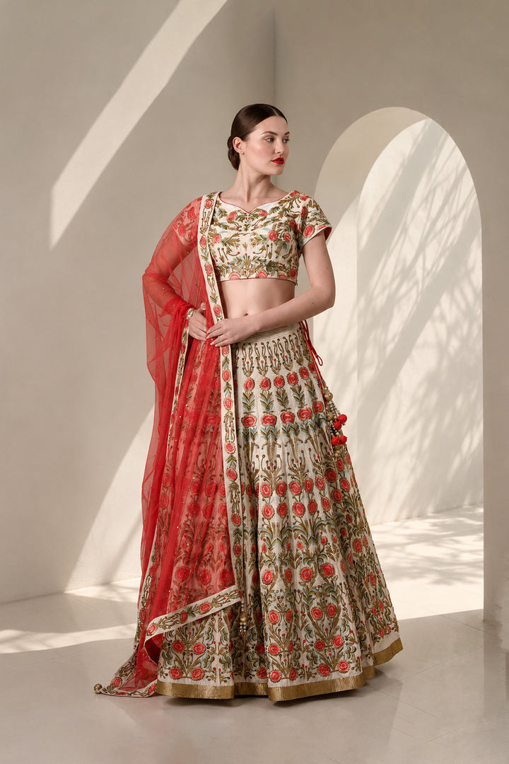 Ivory lehenga set featuring handcrafted floral embroidery on blouse &amp; skirt, a statement flared skirt and vibrant sheer dupatta.
