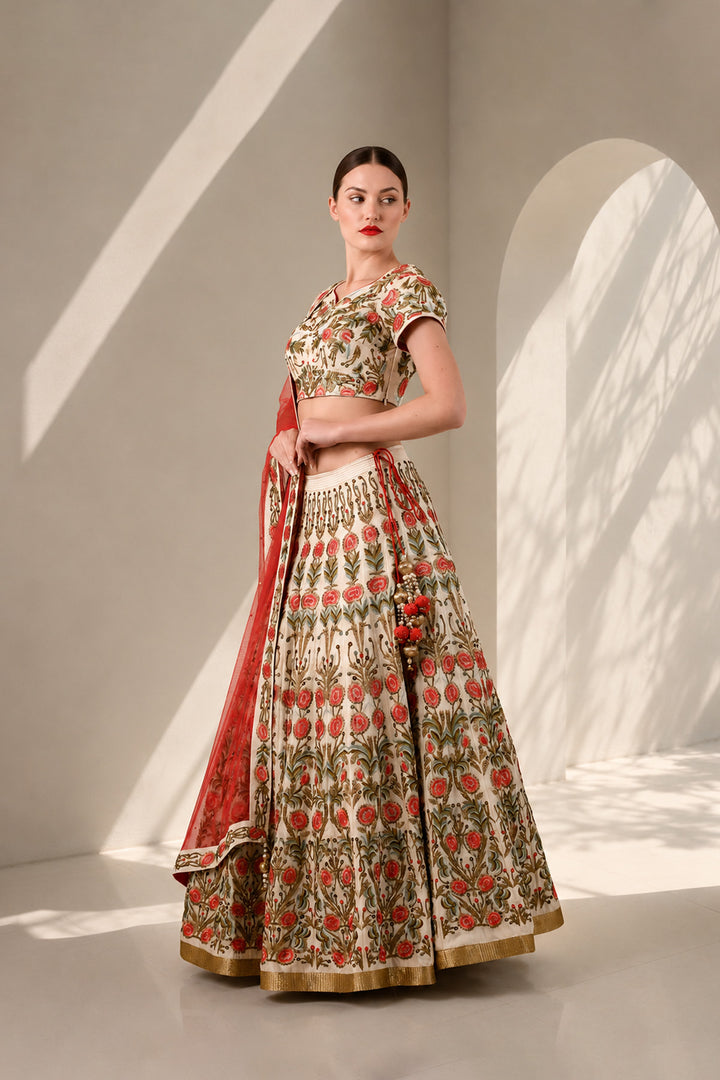 Ivory lehenga set featuring handcrafted floral embroidery on blouse &amp; skirt, a statement flared skirt and vibrant sheer dupatta.