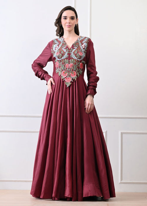 A beautiful maroon dress featuring bold floral embroidery