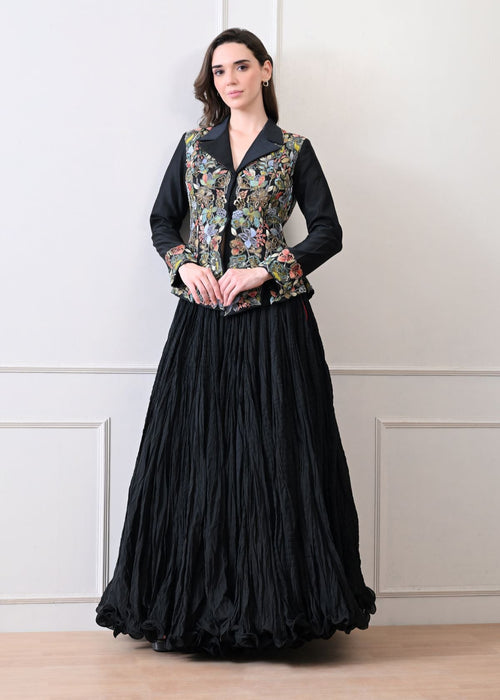 A black jacket features intricate all-over embroidery with skirt