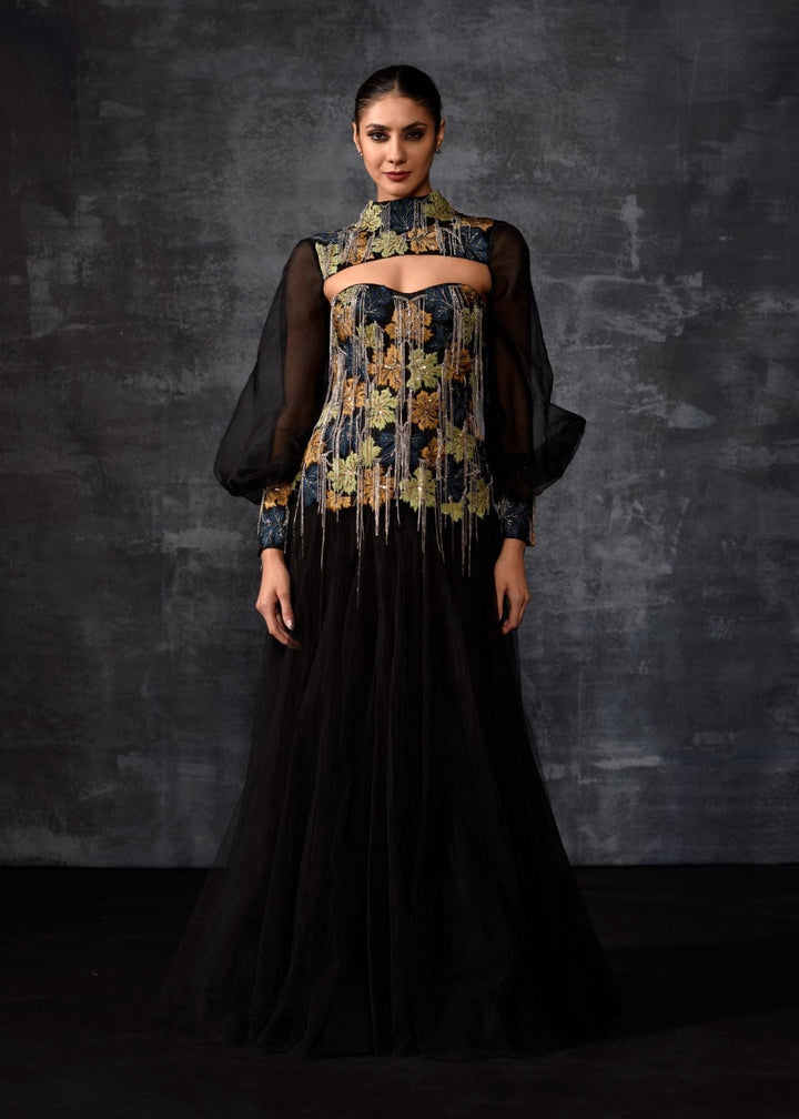 A elegant black off-shoulder gown features a dramatic sleeve top.