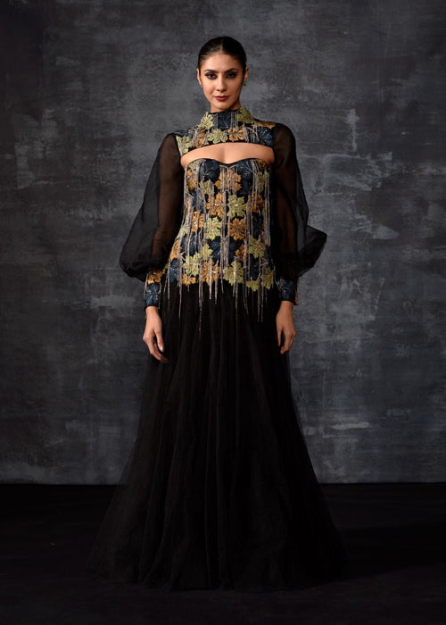 A elegant black off-shoulder gown features a dramatic sleeve top.