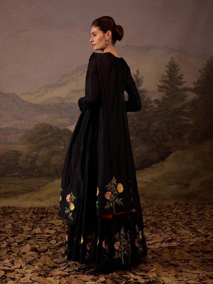 A sophisticated ensemble features a full-length black anarkali.
