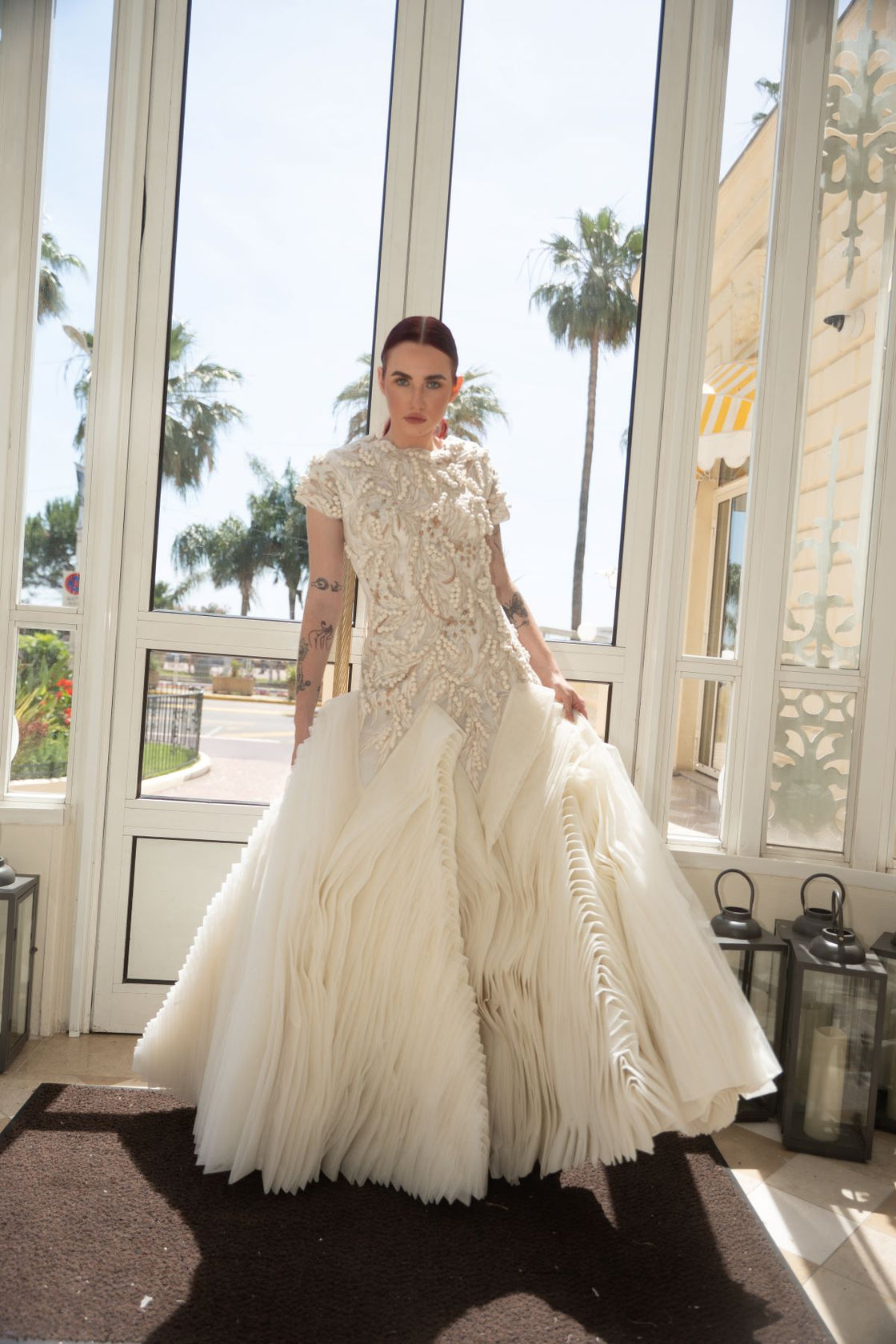 A exquisite gown features a sculpted bodice with ornate bead and thread embroidery