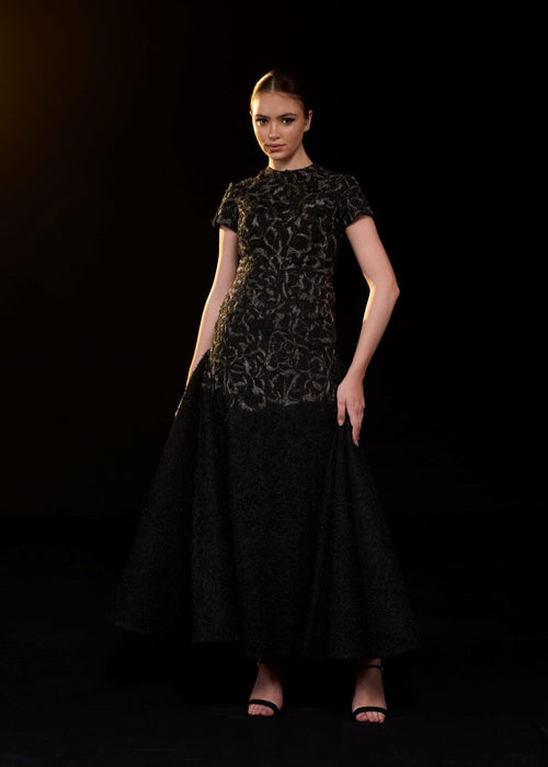 Elegant black gown featuring intricate tonal embroidery.